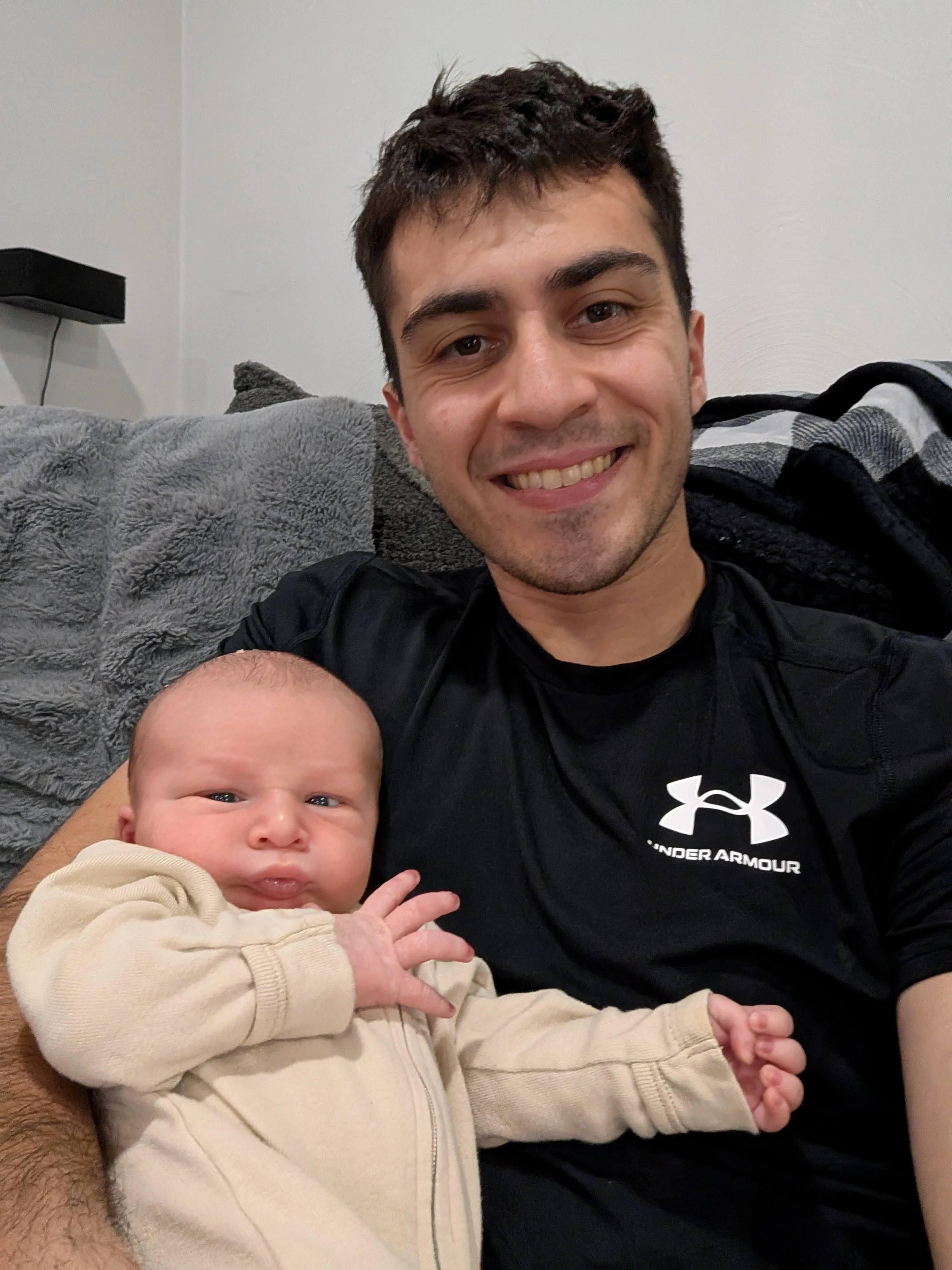Mark holding Nolan on the couch